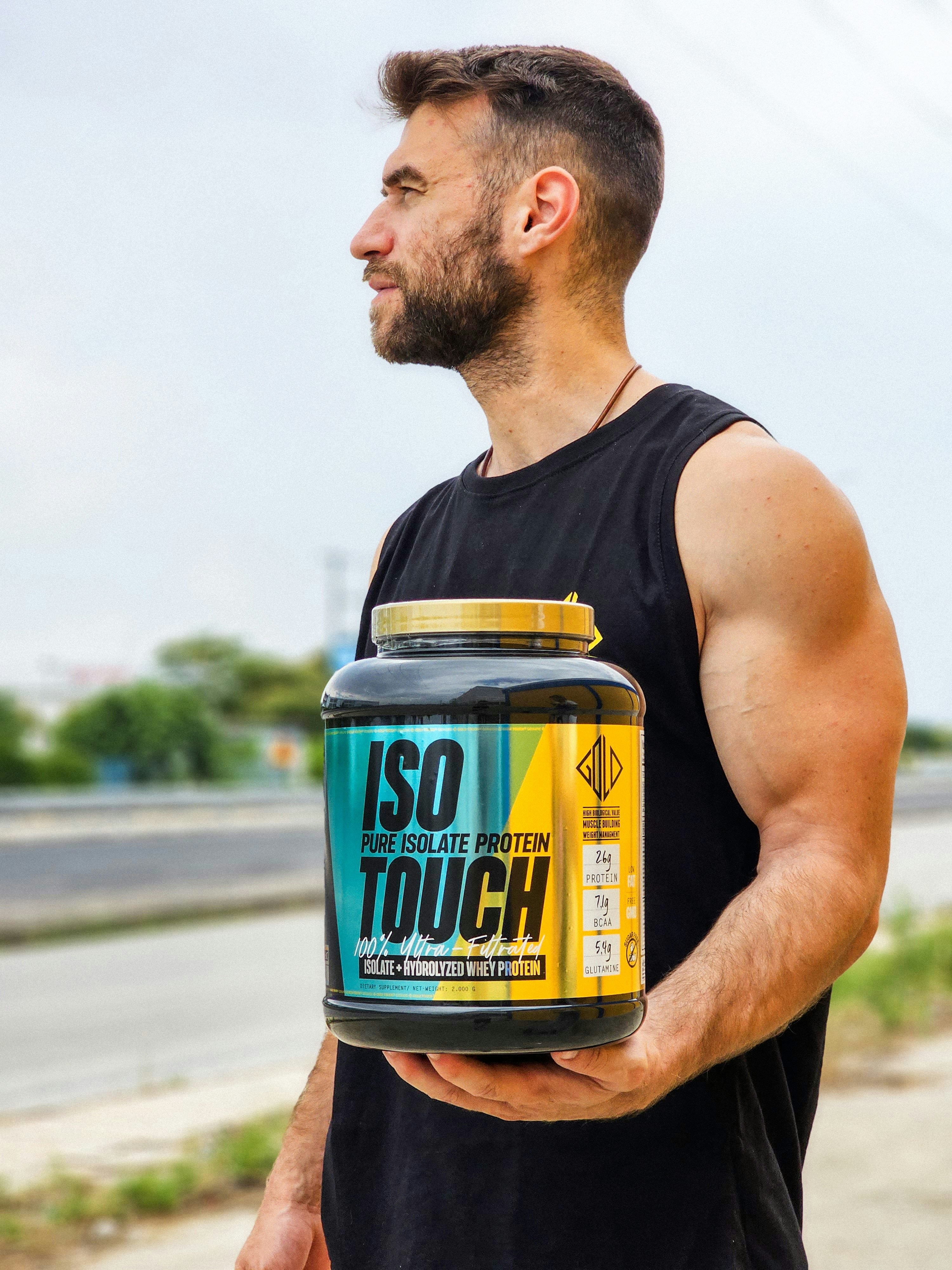 Close-up of a whey protein powder container showing its nutritional label