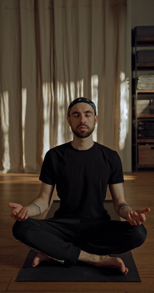 Realistic photograph of a male athlete performing a full‑body strength training exercise, showing progression in muscle development.